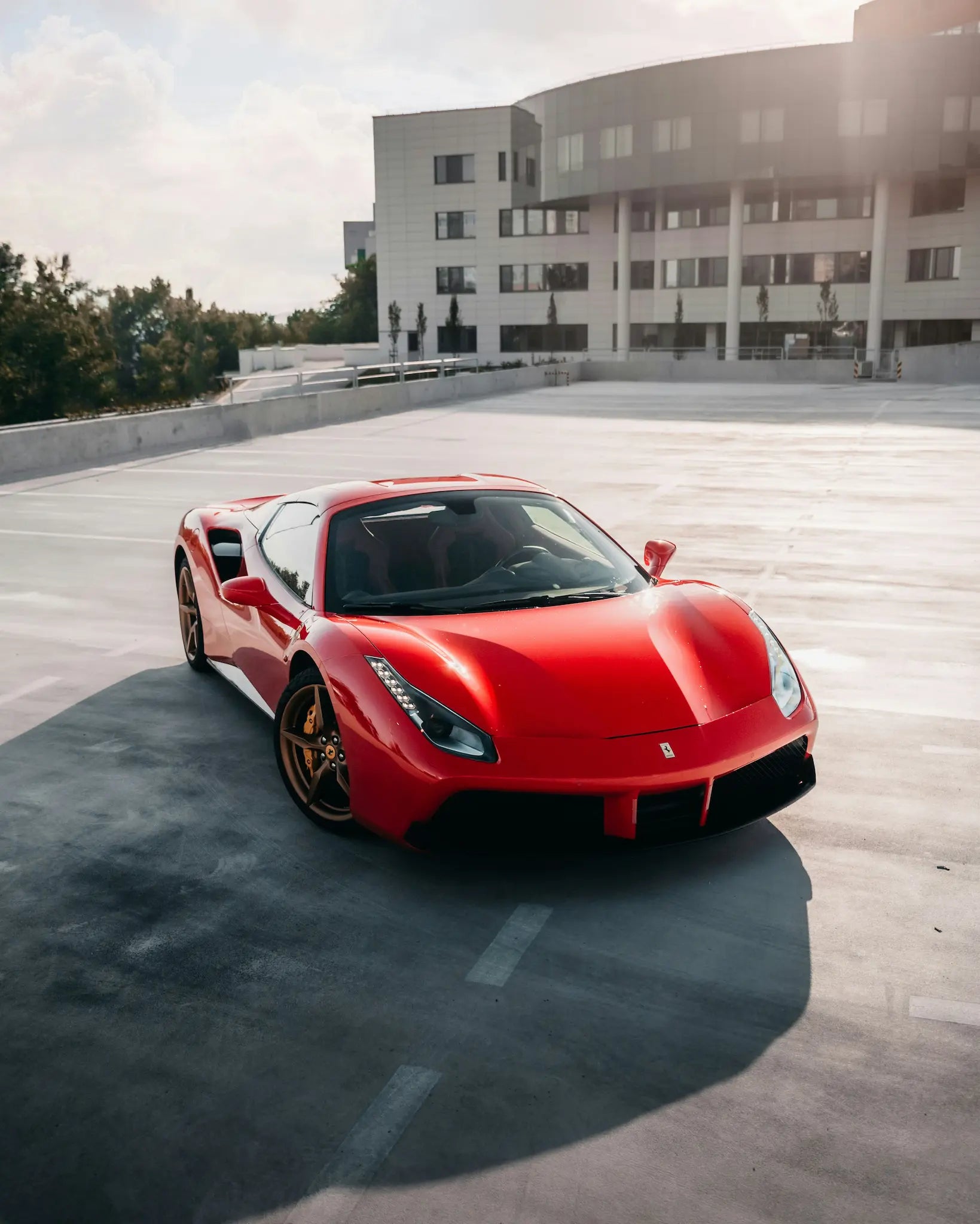 red ferrari in parking lot